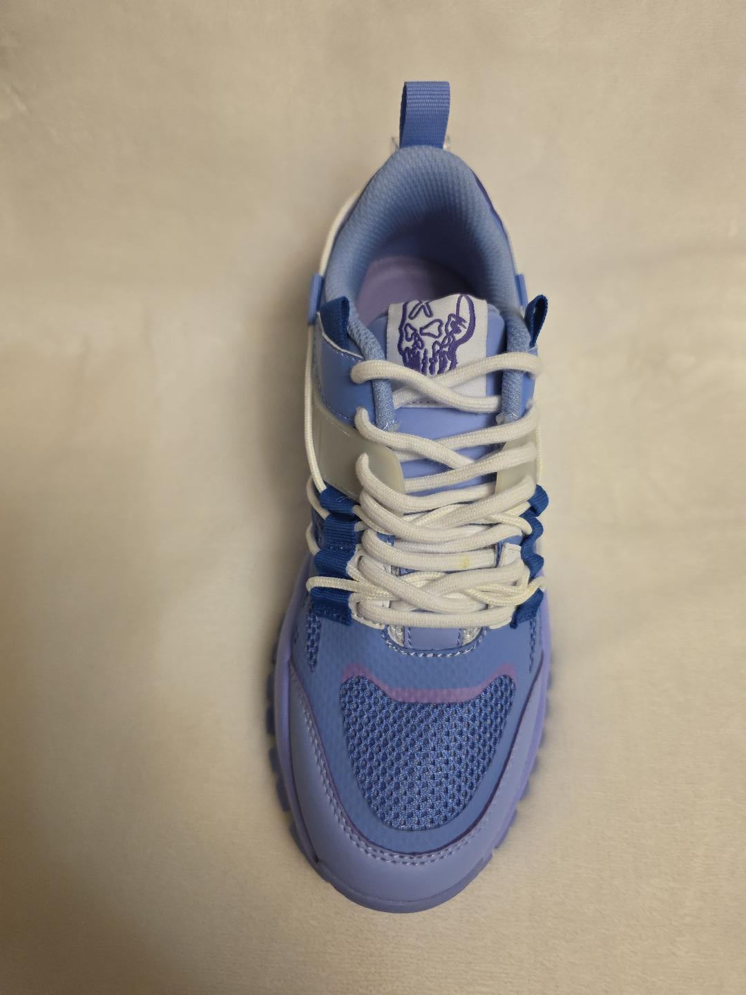 Ultra M Sneakers - top view with skull embroidered tongue badge and white bungee toggle laces