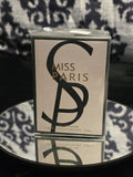 Miss Paris Eau de Parfum 100mL box - sleek warm greige taupe packaging with bold oversized black SP monogram crest and gold MISS PARIS serif typography