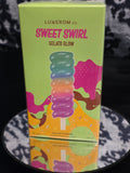 Luxxerom Co. Sweet Swirl Gelato Glow Eau de Parfum 100mL box - vibrant lime green packaging with bold hot pink SWEET SWIRL typography and rainbow gelato popsicle artwork