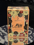 Dorall Collection Miss Blossom Eau de Toilette 100mL box - warm amber orange packaging with rich black floral botanical artwork featuring cream yellow and deep red blossoms