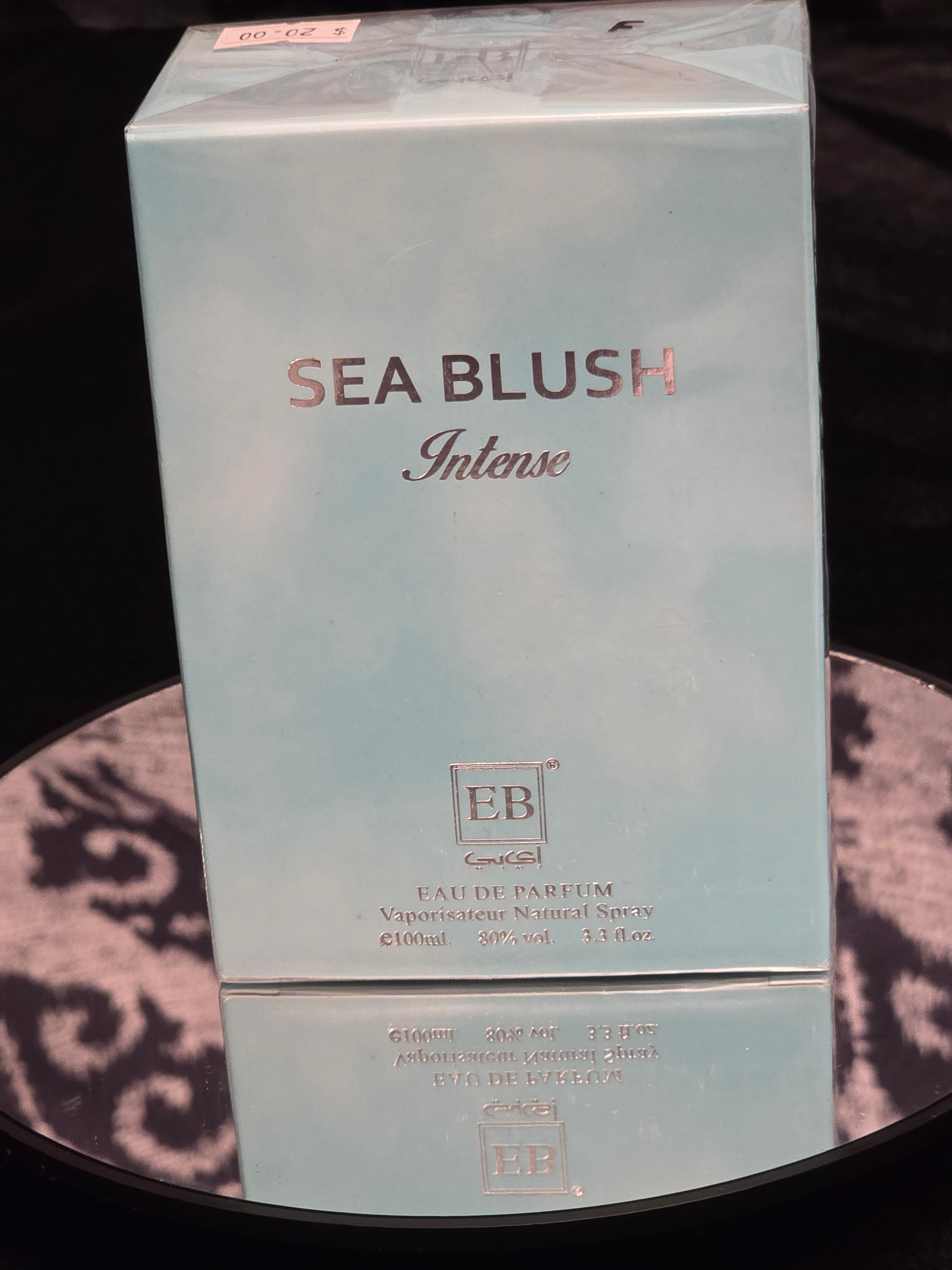 EB Sea Blush Intense Eau de Parfum 100mL box - soft powder blue mist packaging with rose gold SEA BLUSH Intense typography and embossed EB square crest logo