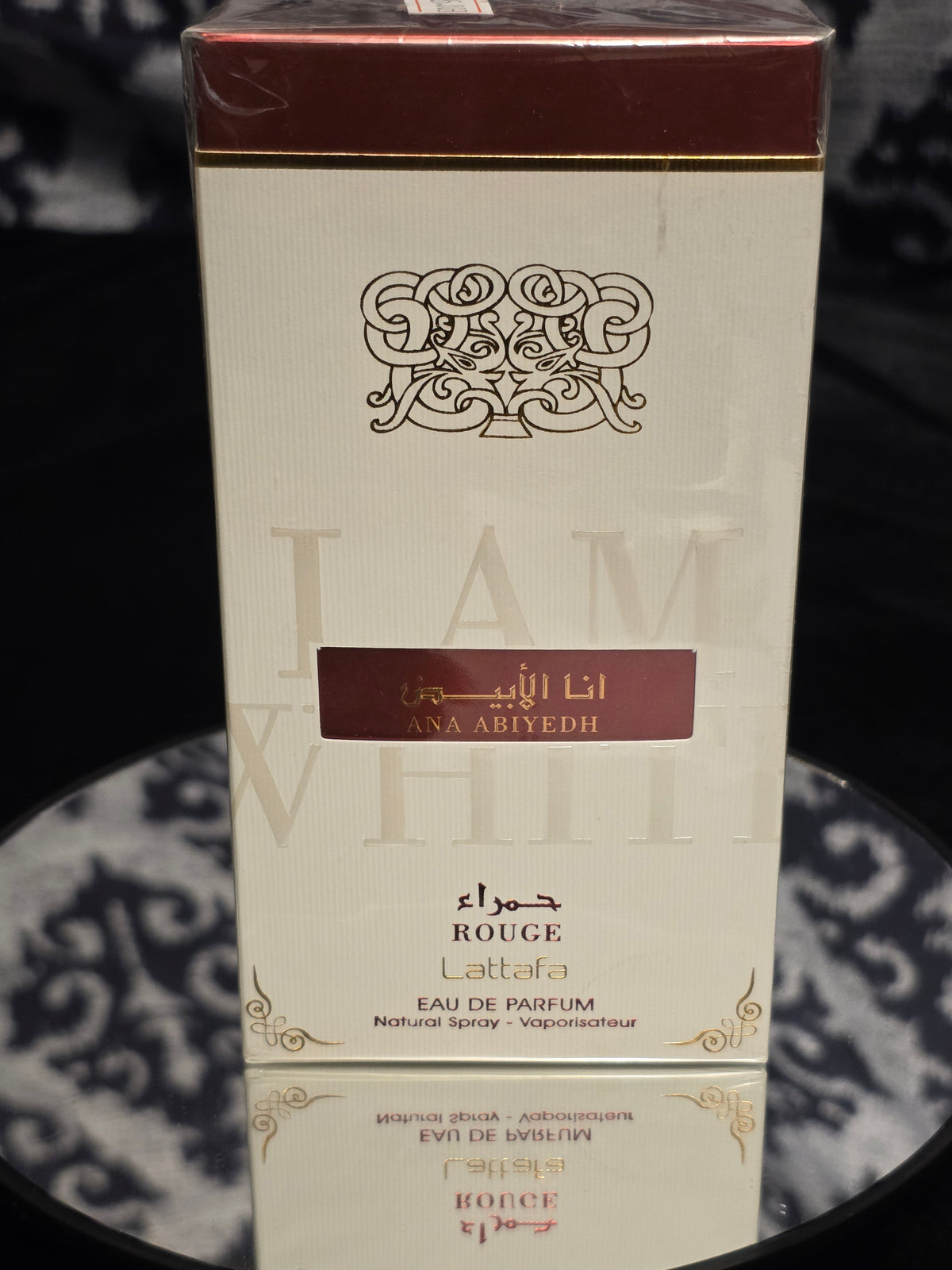 Lattafa Ana Abiyedh Rouge Eau de Parfum 100mL box - elegant white packaging with deep burgundy rouge accent panel, Arabic calligraphy and ornate Lattafa arabesque crest