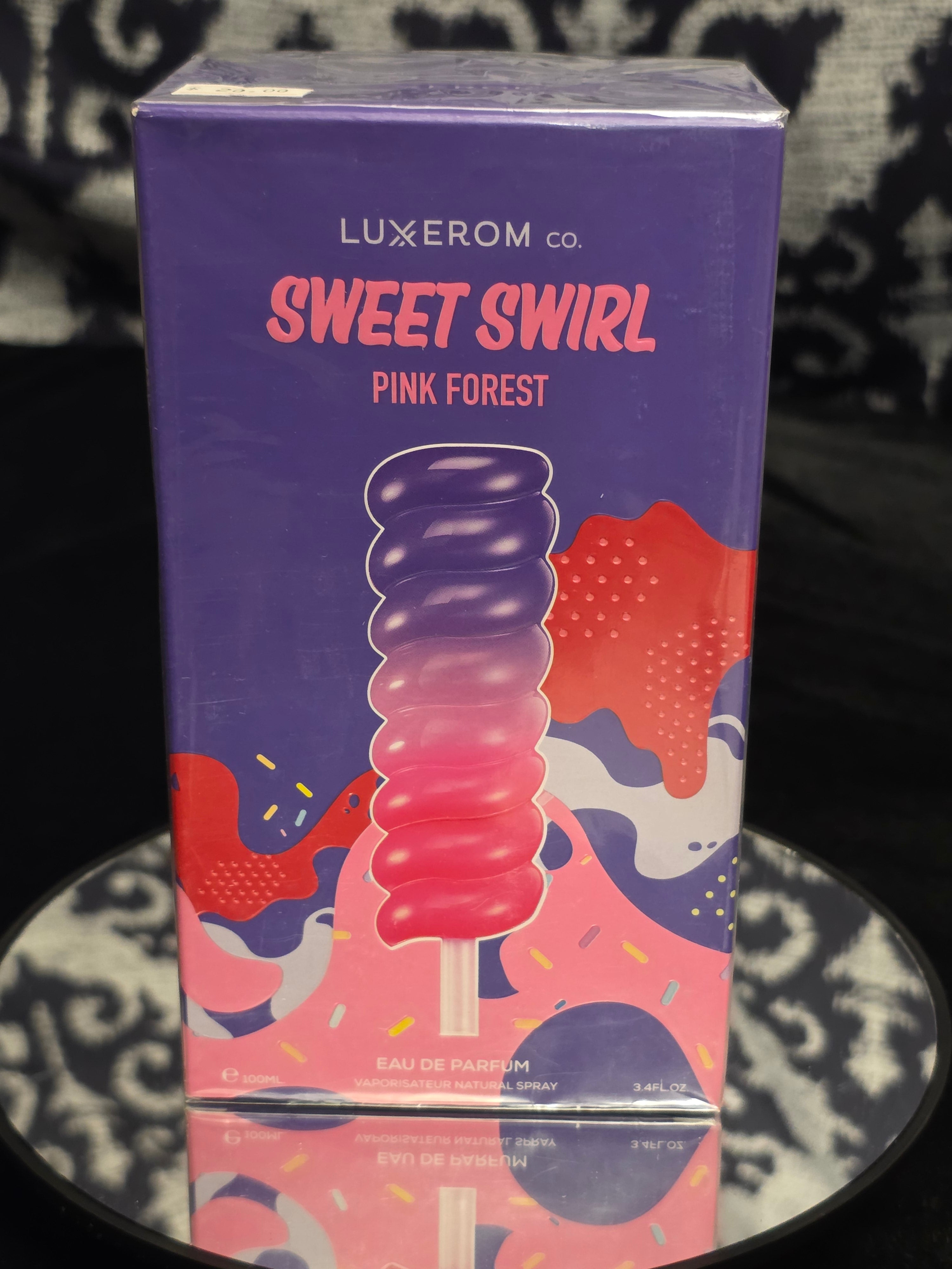 Luxxerom Co. Sweet Swirl Pink Forest Eau de Parfum 100mL box - bold deep purple packaging with pink to purple gradient swirl popsicle artwork and candy splatter design