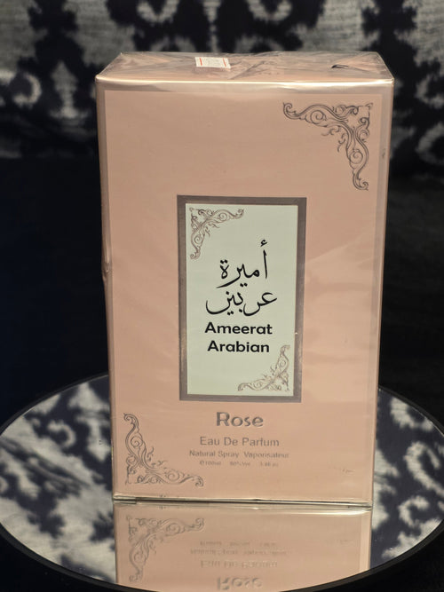 Ameerat Arabian Rose Eau de Parfum 100mL box - soft blush pink packaging with silver filigree corner detail and Arabic calligraphy label